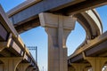 Section of elevated highway with several levels against a bright blue sky in Houston, Texas