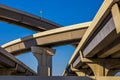 Section of elevated highway with several levels against a bright blue sky in Houston, Texas