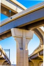 Section of elevated highway with several levels against a bright blue sky