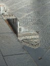 Section of the facade of Santa Maria del Fiore in Florence, reflected in a rain puddle in the street