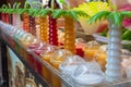 Section of freshly prepared juices from tropical fruits in shop-window counter Royalty Free Stock Photo