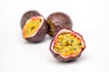 Section of a passion fruit with colourful seeds on a white background