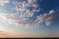 Section of sky with altocumulus clouds above fields before sunset Royalty Free Stock Photo