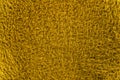 A section of thick woven material in yellow color with visible dense thin hair