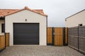 Sectional tilting black garage door and entrance gate of modern new house Royalty Free Stock Photo