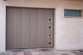 Sectional tilting grey garage door gray entrance gate of modern new house Royalty Free Stock Photo