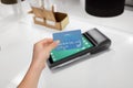 Secure card payment at sleek POS terminal. Hand holding credit card for transaction