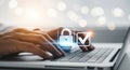Secure data entry hands typing on laptop with digital lock and checkmark symbol technology Royalty Free Stock Photo