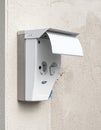 Secure Outdoor Electrical Socket on Stucco Wall Royalty Free Stock Photo