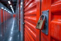 Secure padlock on vibrant orange self storage unit door showcasing rental storage space availability Royalty Free Stock Photo