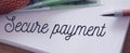 Secure payment words on page of copybook and euro banknotes on it. Online business web payments security concept. No