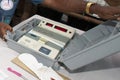 secured electronic voting machine (EVM) inside container during election process.