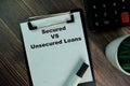 Secured Vs Unsecured Loans write on a paperwork isolated on Wooden Table