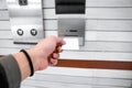 securing lift or elevator access control, man's hand is holding a key card lay up to insert in card hold for unlocking elevator