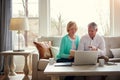 Securing themselves for a comfortable retirement. a mature couple going over their finances at home. Royalty Free Stock Photo