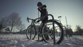 Security and antitheft lock for a bicycle. Man cyclist unlocks cycle in an outdoor bike parking lot in a European city