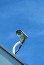 Security camera against blue sky Royalty Free Stock Photo