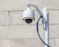Security camera, CCTV in front of brick background Royalty Free Stock Photo