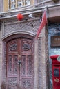 Security camera and Chinese flag over locked door, Kashgar, Xinjiang, CHina