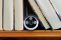 Security camera hidden among some books for surveillance of the interior of the home. Royalty Free Stock Photo