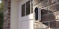 Outdoor security camera mounted on brick wall near entrance of a home during daytime Royalty Free Stock Photo
