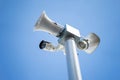 Security camera with loudspeakers and megaphone on the sky background