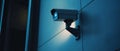 A Security Camera Mounted on a Blue Wall Royalty Free Stock Photo