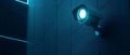 Security Camera Mounted on a Blue Wall with a Glowing Light Royalty Free Stock Photo