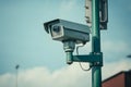 A security camera mounted on a traffic pole. AI Generated