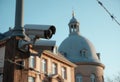 Security camera monitoring a historic building with a dome in the background Royalty Free Stock Photo