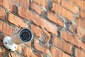 Security camera on red brick wall Royalty Free Stock Photo