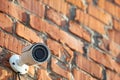 Security camera on red brick wall Royalty Free Stock Photo