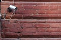 Security camera on a red brick wall. Royalty Free Stock Photo