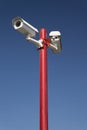 Security camera on red pillar,blue isolated Royalty Free Stock Photo