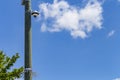 Security camera and urban video in front of blue sky. Outdoor cctv video surveillance cameras. Safety system area control outdoor Royalty Free Stock Photo