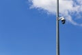 Security camera and urban video in front of blue sky. Outdoor cctv video surveillance cameras. Safety system area control outdoor Royalty Free Stock Photo