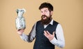 Security and cash money savings. Banking concept. General savings tips. Man bearded hipster hold jar full of cash Royalty Free Stock Photo