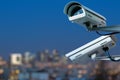 security CCTV camera monitoring system with panoramic view of a city on blurry background