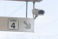 Security CCTV camera and a sign pointing to the way on Linha