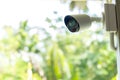 Security CCTV camera surveillance system outdoor of house. A blurred night city scape background. Modern CCTV camera on a wall.