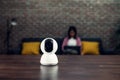 Security CCTV camera, surveillance technology on the table and blur background woman sitting on sofaÃ Â¹Æ Royalty Free Stock Photo