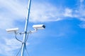 Security cctv cameras on pole blue sky background. Royalty Free Stock Photo