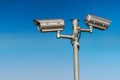 Security CCTV video camera against blue sky. Royalty Free Stock Photo