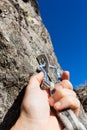 Security concept: climber inserts a quick-draw in anchor on rock Royalty Free Stock Photo