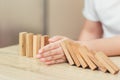 Security concept, woman hand stopping risk the wooden blocks