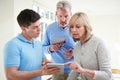 Security Consultant Demonstrating Alarm System To Mature Couple Royalty Free Stock Photo