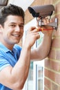 Security Consultant Fitting Camera To House Wall Royalty Free Stock Photo