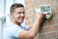 Security Consultant Fitting Security Light To House Wall Royalty Free Stock Photo