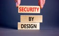 Security by design symbol. Concept words Security by design on wooden blocks on a beautiful grey table grey background. Royalty Free Stock Photo