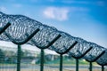 Security fence barbed wire blue sky background